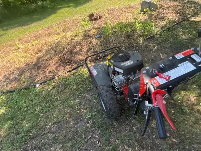 Forestry mulcher clearing brush and thick vegetation on rural property